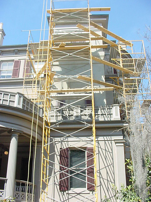 the birthplace with yellow scaffolding on an exterior side wall