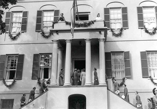 the birthplace with many girl scouts around the house celebrating