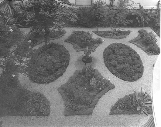 a formally designed garden with rocks, grass and plants