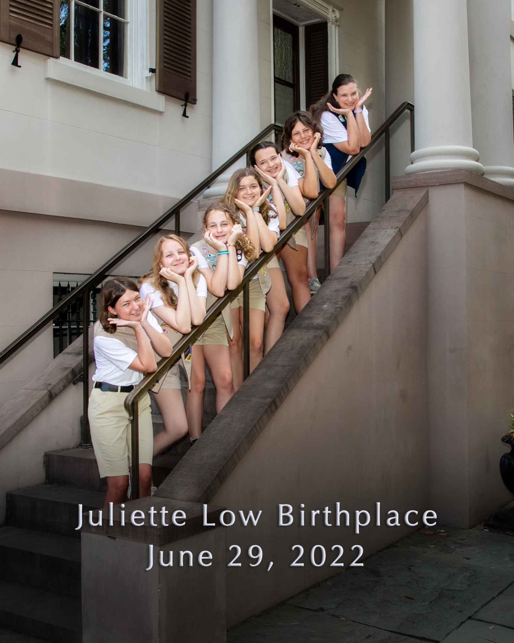 A group of Girl Scouts posing on the front steps of the Juliette Gordon Low Birthplace.